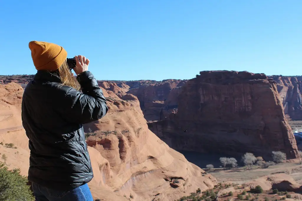 Linn Williams looking through binoculars